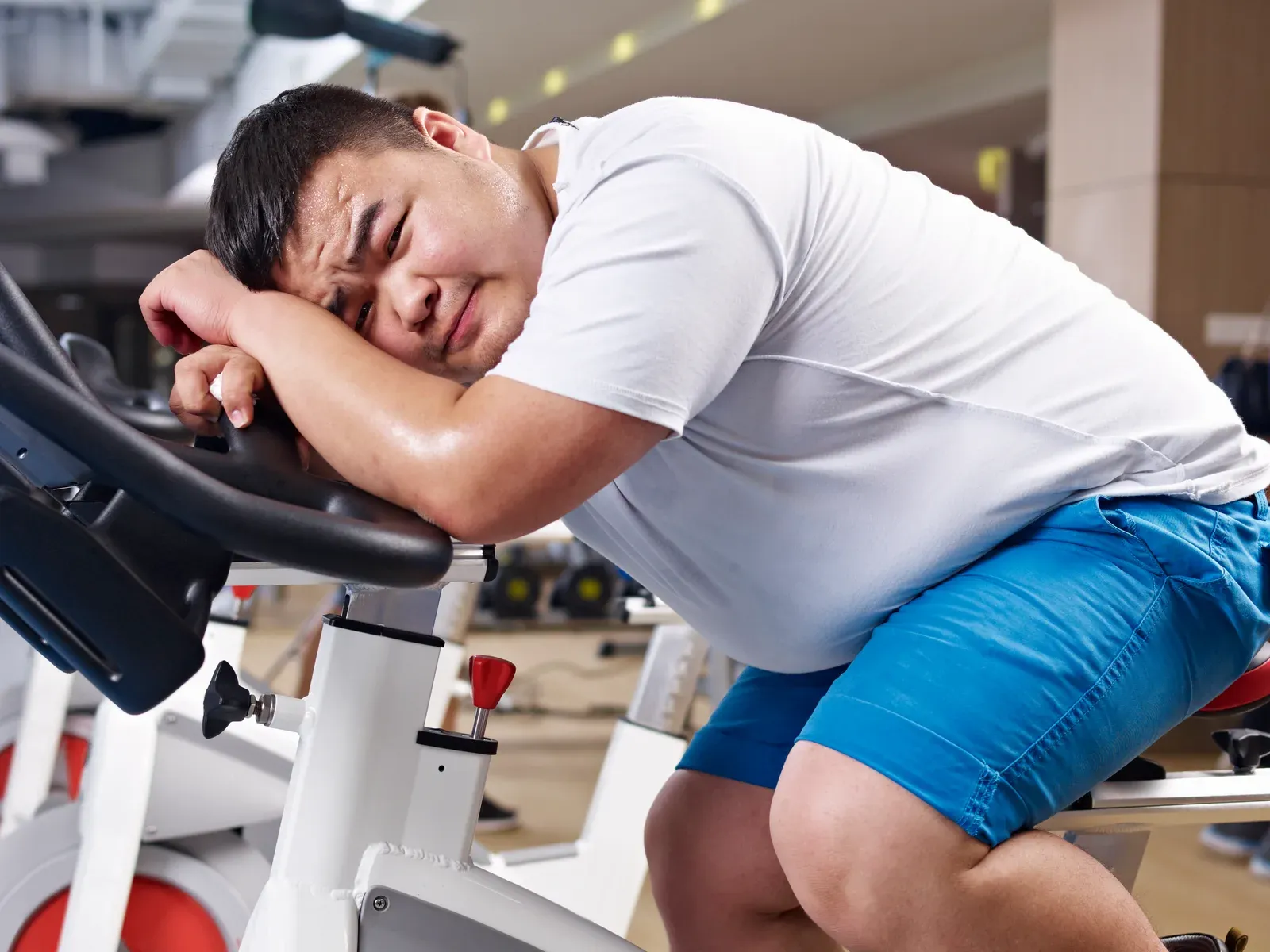 Overweight man working out at his own pace