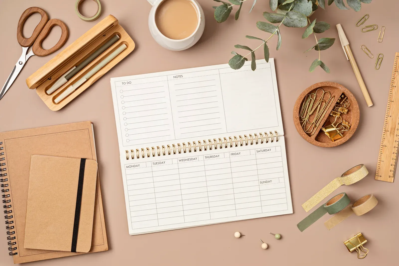 Weekly planner laid out with office stationery, ready for scheduling training days