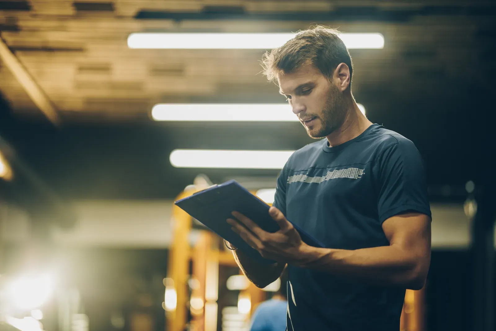 A fitness instructor reviewing a written training plan before a session