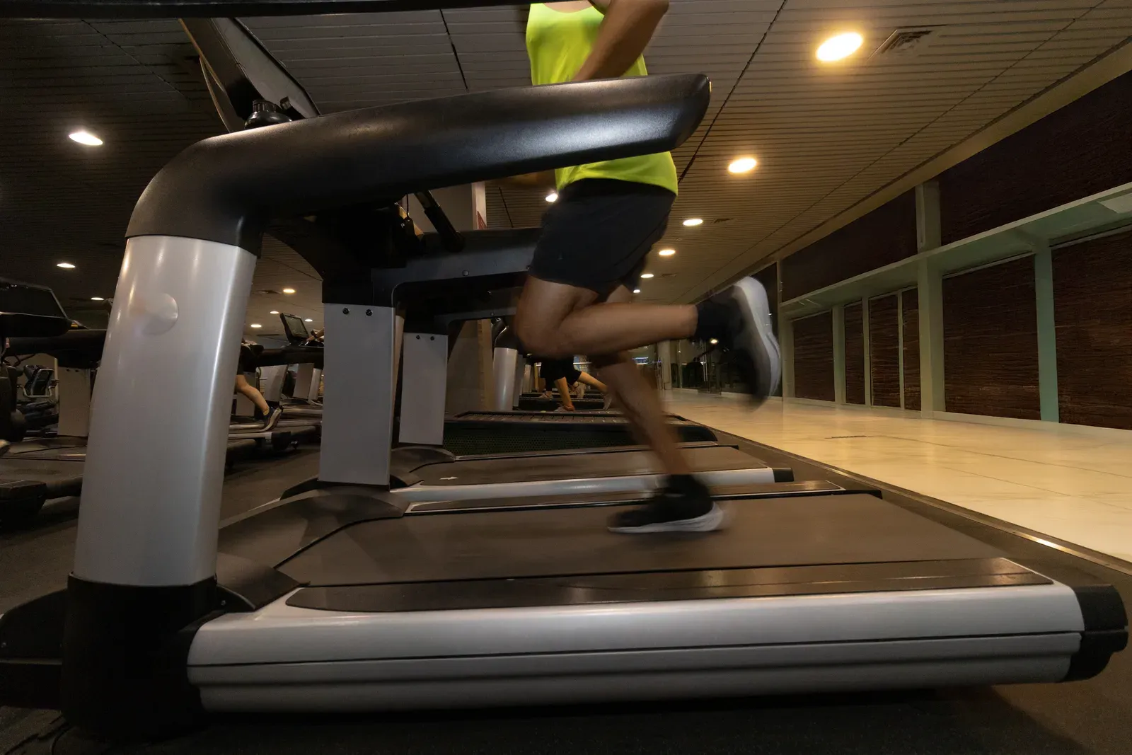 A runner's legs mid-stride on a treadmill during a steady cardio session