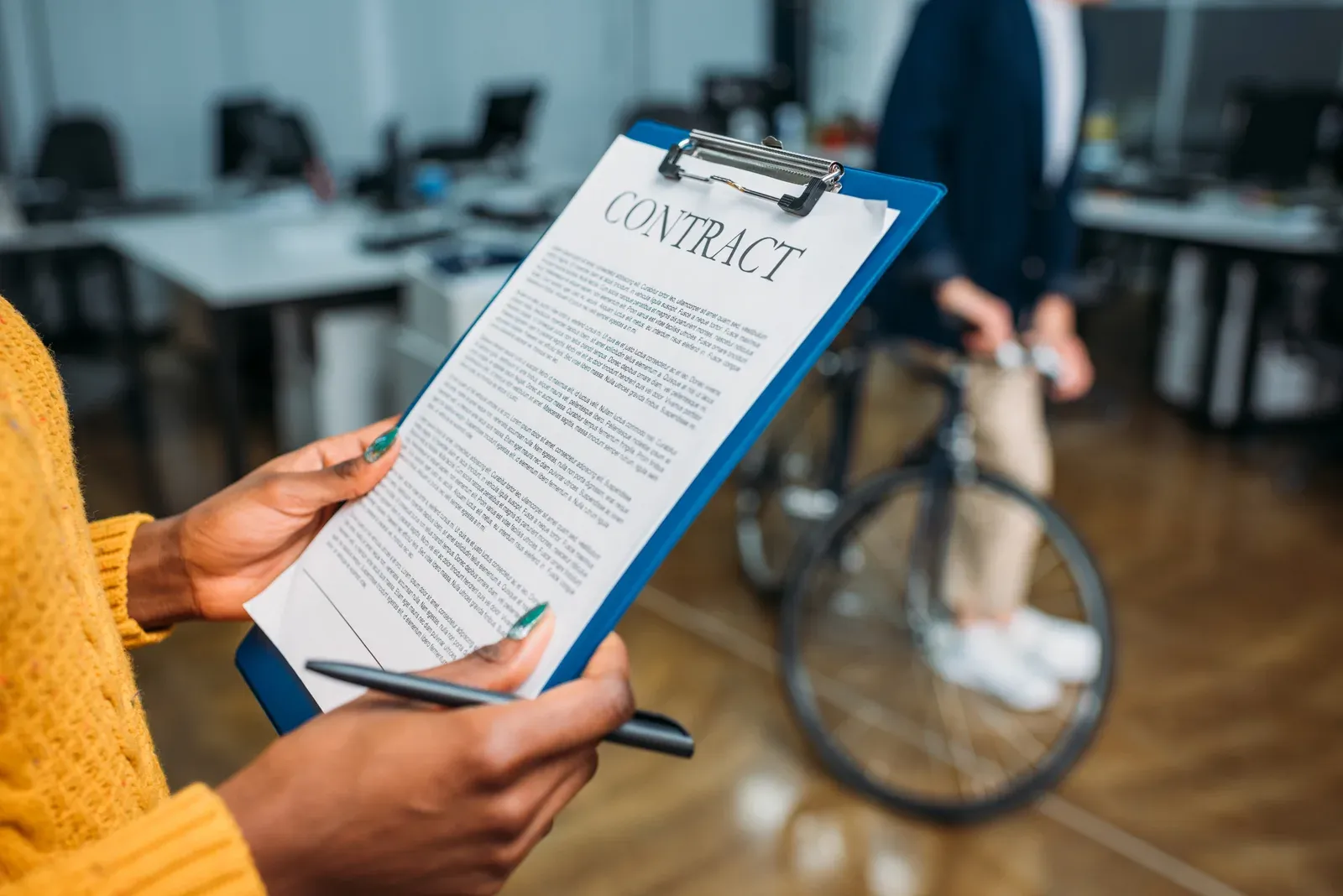 A woman reading through the pages of a contract before signing