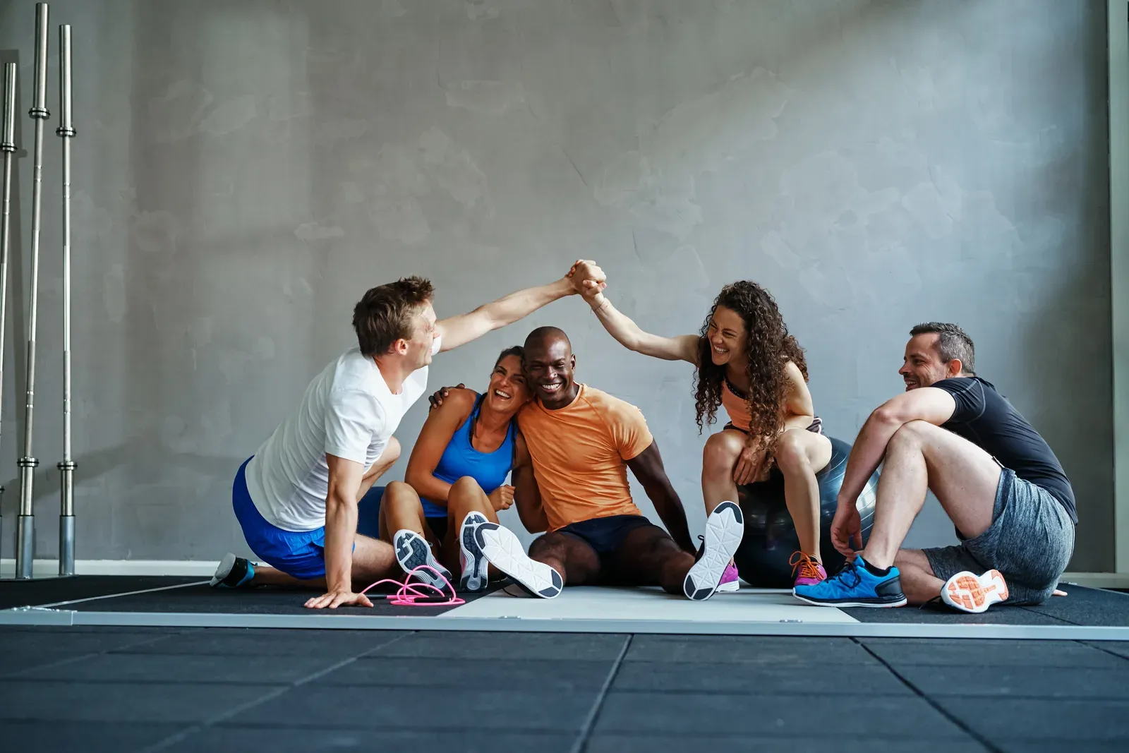Friends sharing high fives on the gym floor after a workout worth the effort