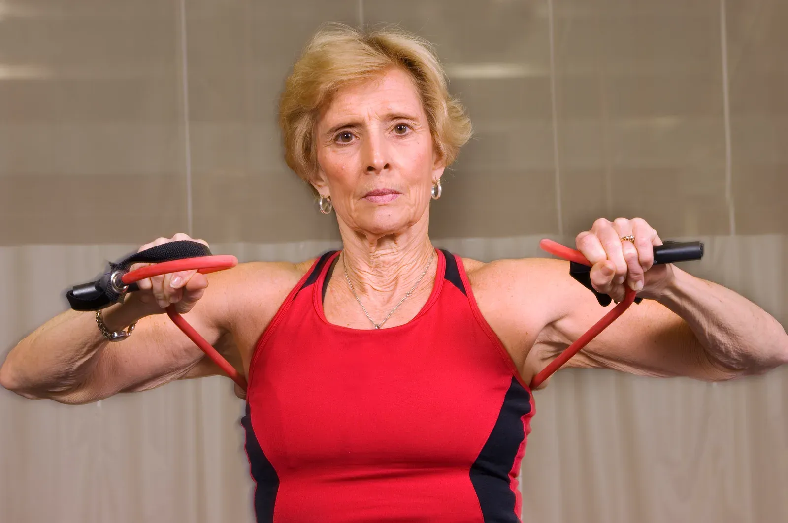 A coach guiding a client through a slow, controlled cable exercise