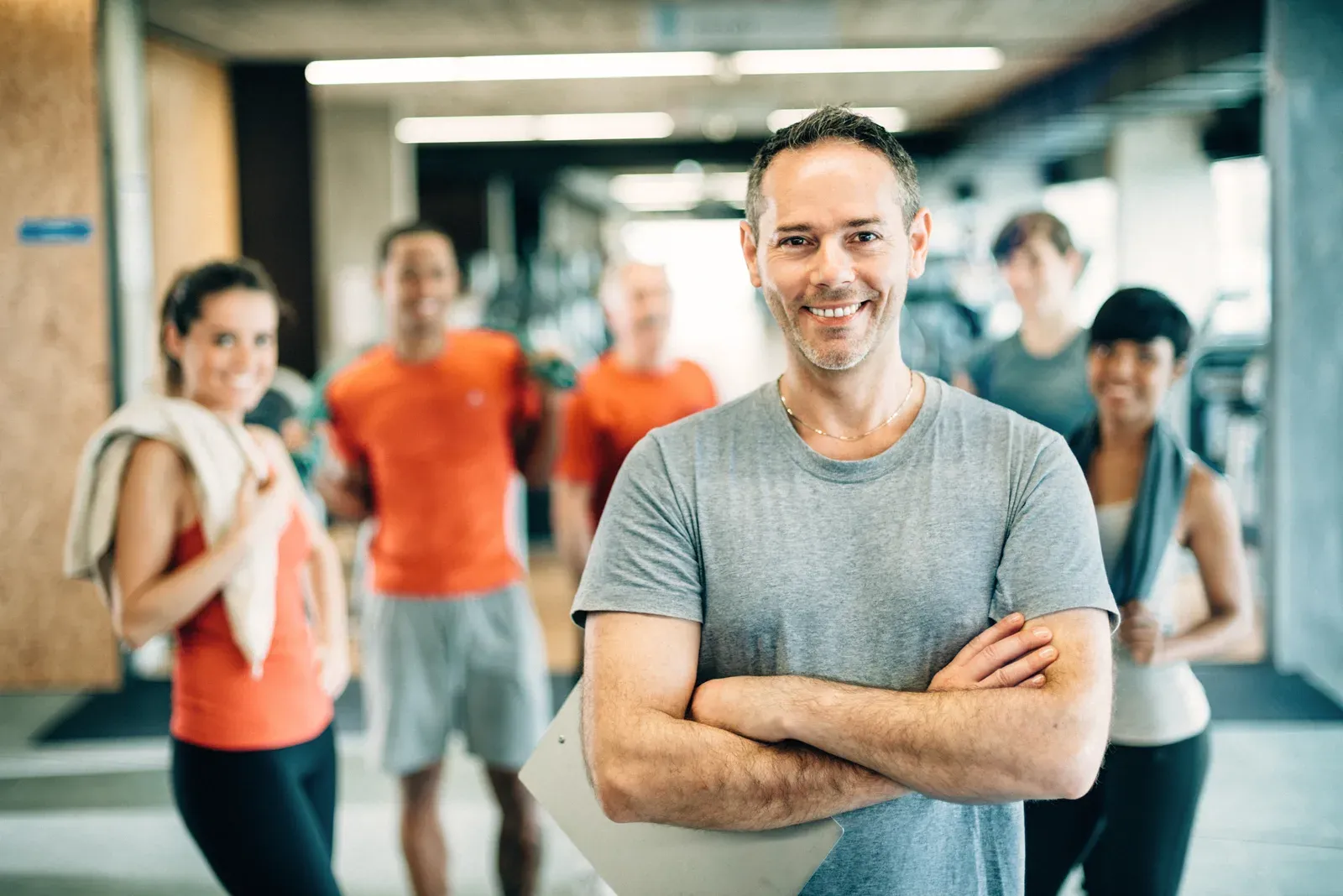 Busy gym floor with a diverse group of people working out