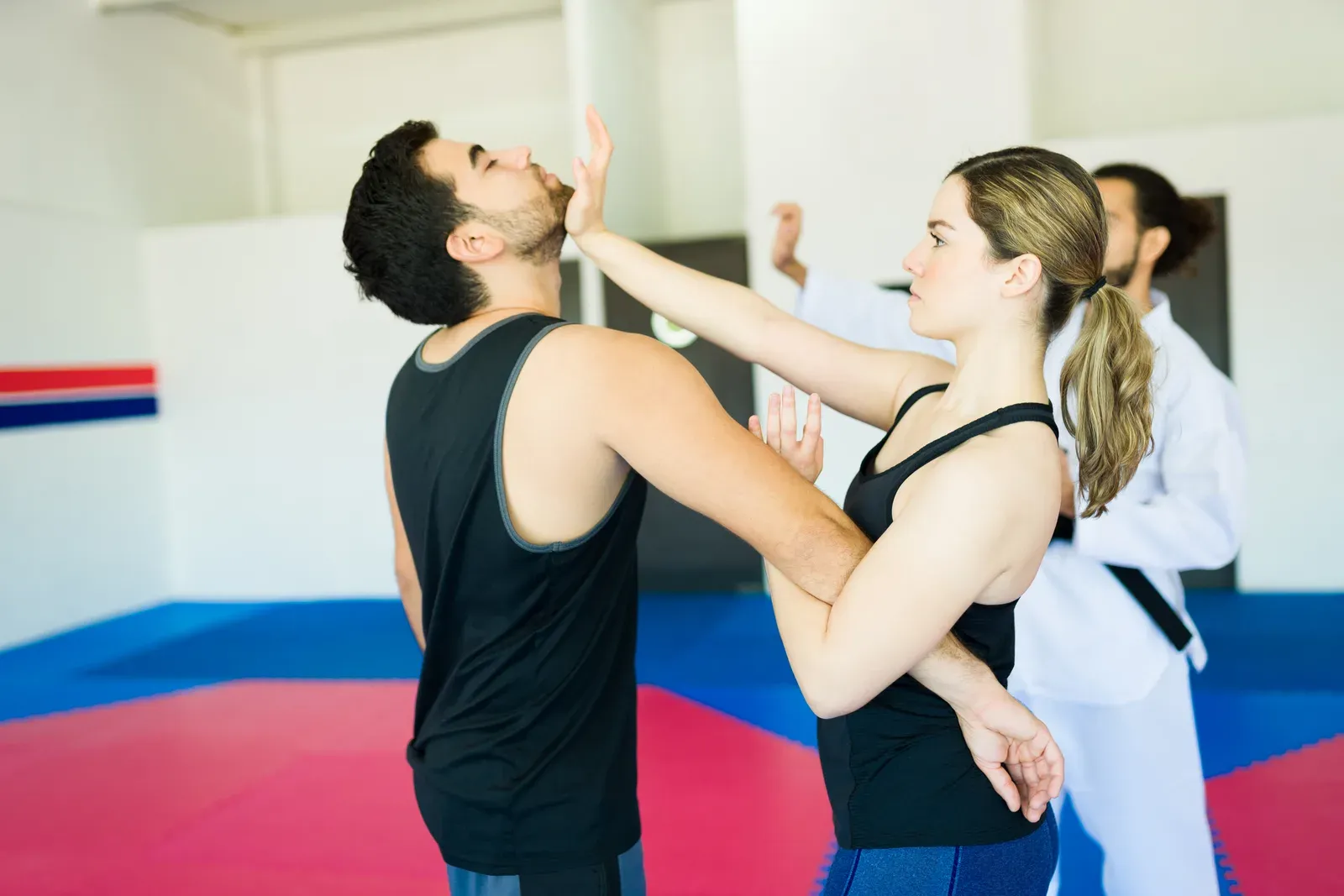 A woman practicing a defensive technique during a self-defense class