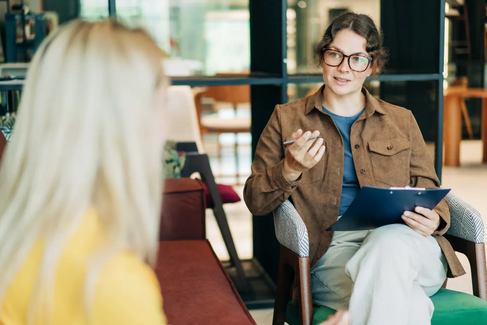 Professional woman leading a one-on-one consultation and taking a client through questions