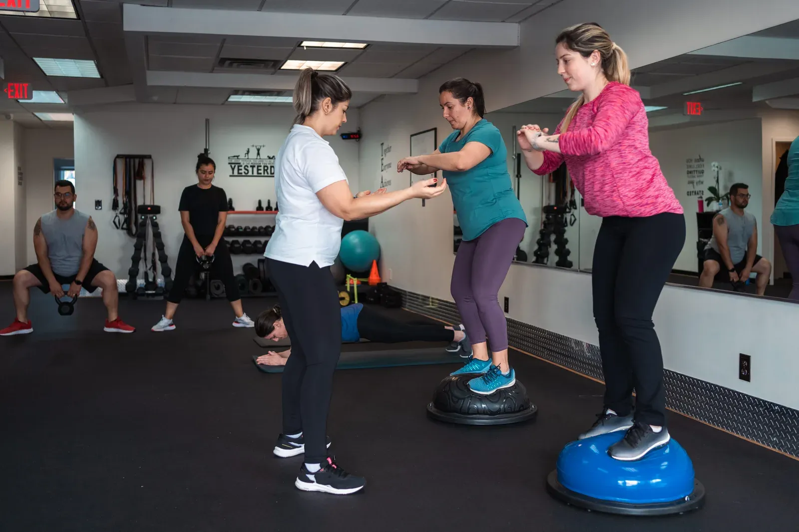 Several people training together in a shared gym session