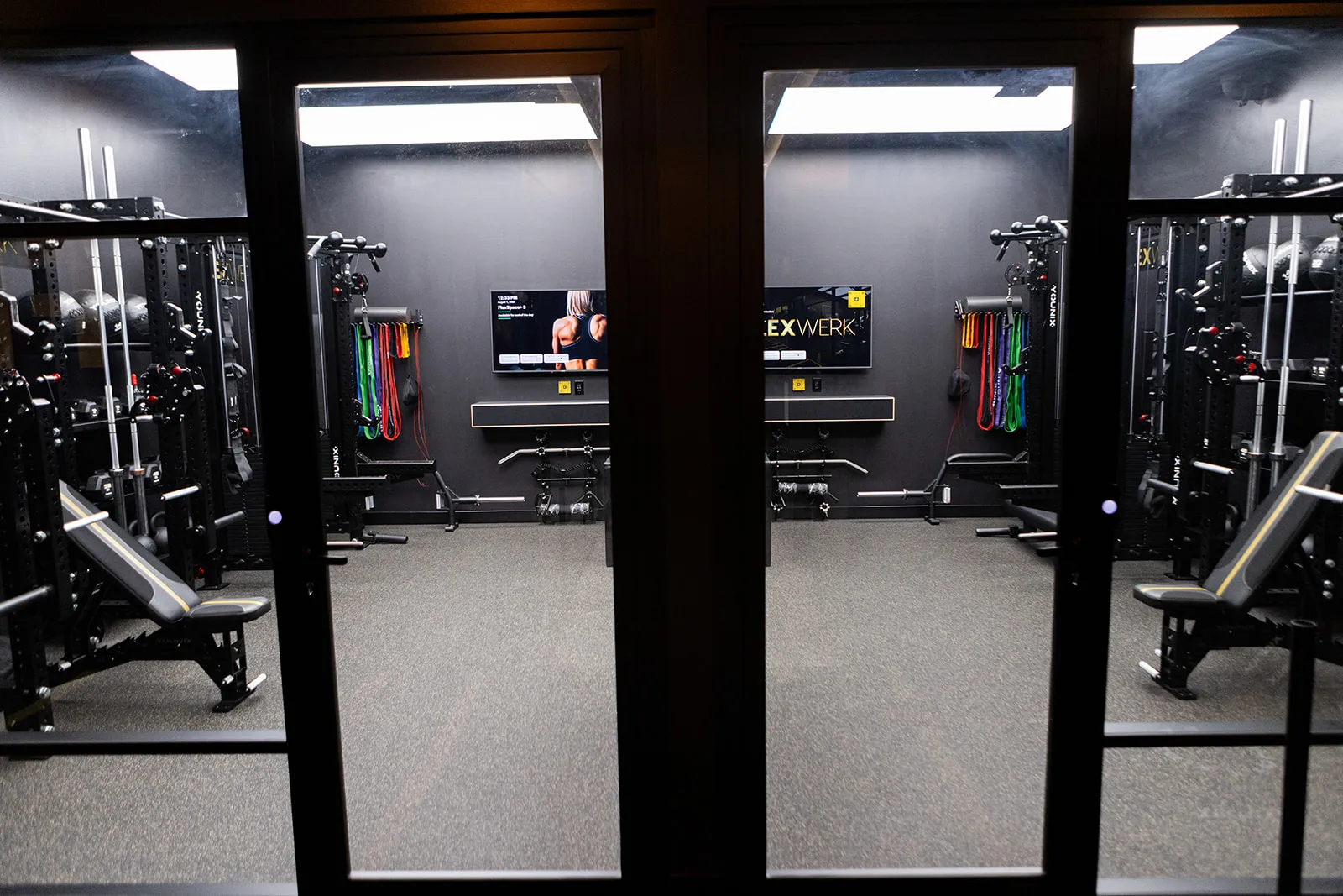 Glass doors along the row of private FlexSpace training rooms at FlexWerk Carmel